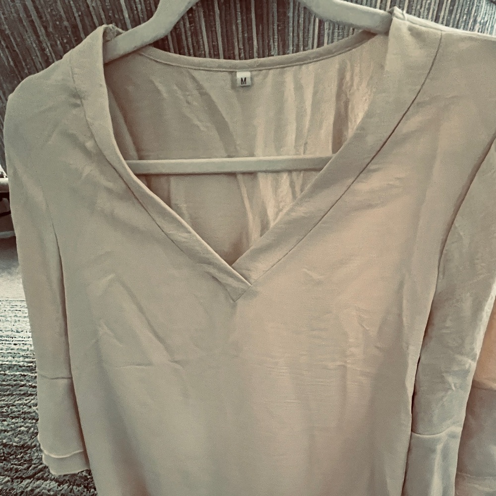 Size Medium beige colored blouse with v neck and bell sleeve
